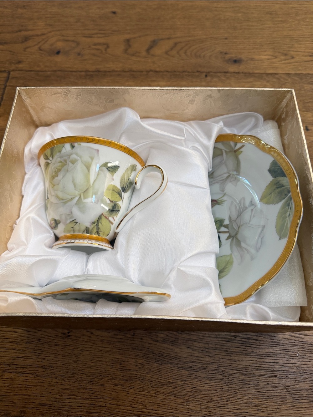 Porcelain Teacup and Saucer Set with White Rose Motif and Gold Trim